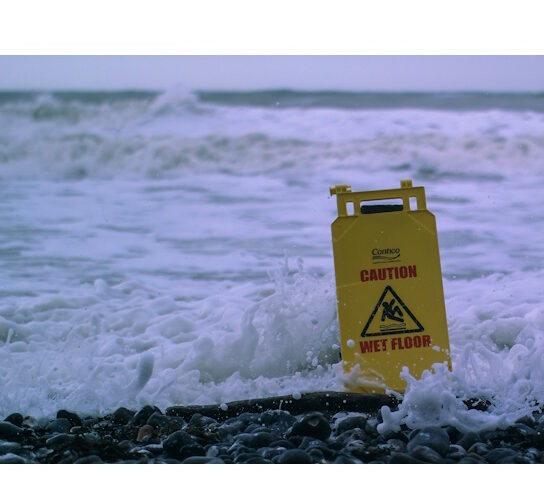 Stock buying process: know the risks! Cautio wet floor sign in ocean surf