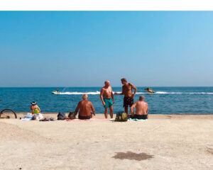 Senior citizens enjoying a sunny day at oceanfront beach