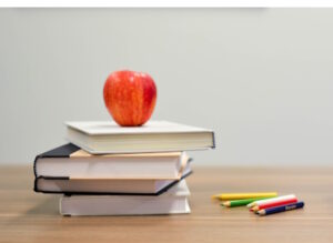 Apple on top of pile of books