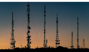 Telecommunications towers seen from a distance at dusk
