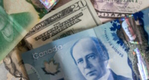 A U.S. 20-dollar bill and a Canadian 5-dollar bill