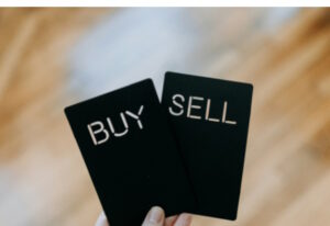 Two black cards. One says Buy, the other Sell