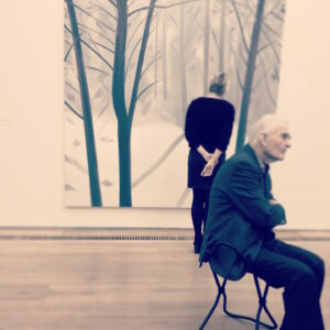 Two people staring intensely at artwork in a museum or gallery